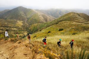 Guests participating in a guided hike at The Ranch Malibu, surrounded by the scenic hills of Malibu.